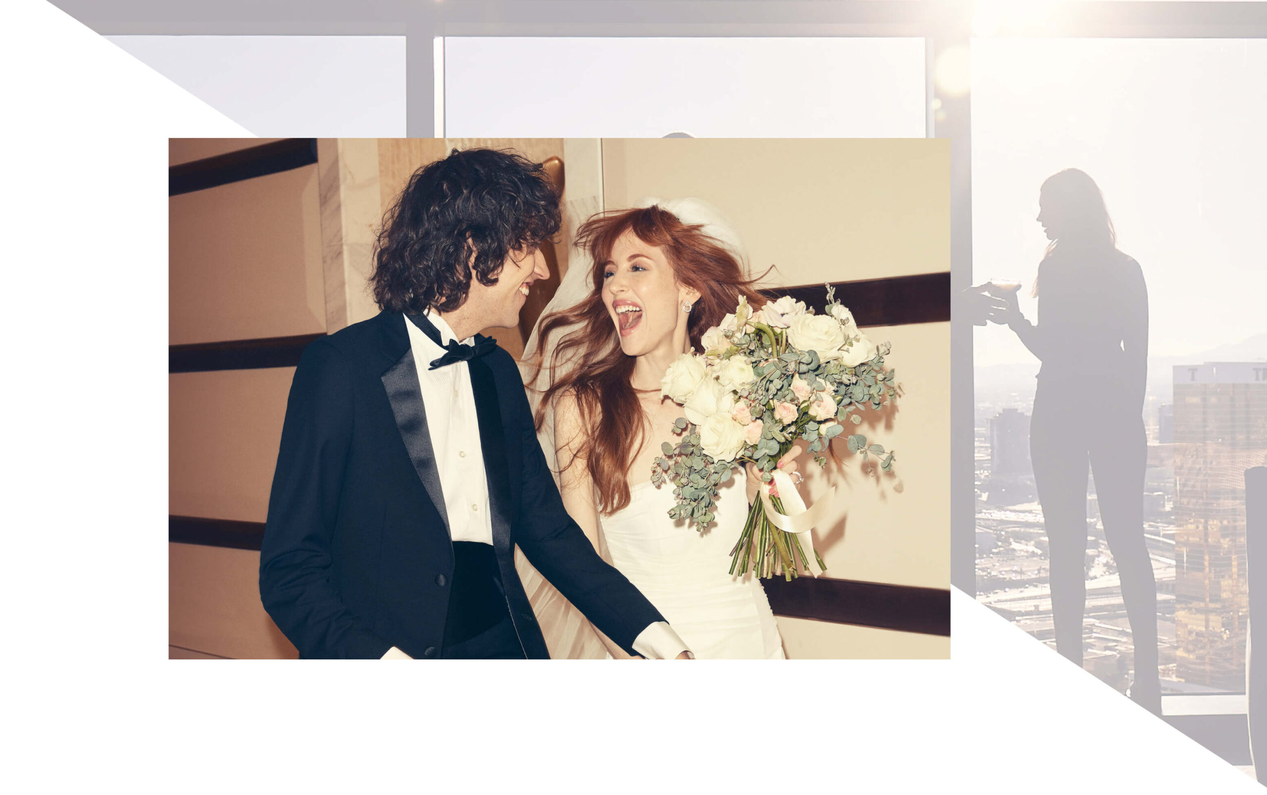 A joyful bride and groom dressed in wedding attire, laughing and holding hands, with the bride carrying a bouquet of white and pastel flowers.