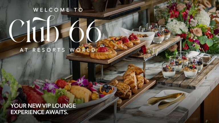 Elegant VIP lounge buffet with pastries, fruit, yogurt parfaits, and floral arrangements at Resorts World.