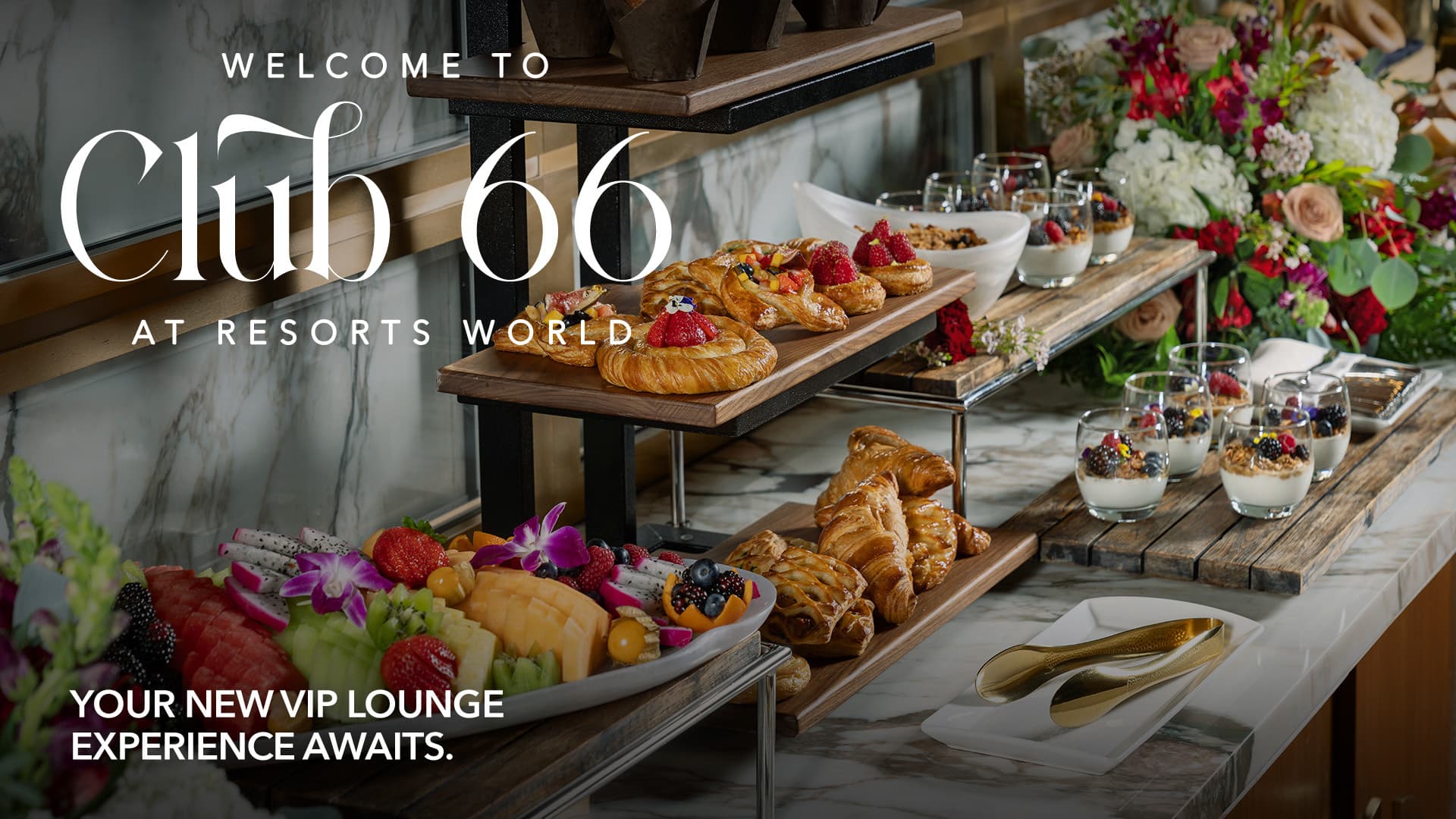 Elegant VIP lounge buffet with pastries, fruit, yogurt parfaits, and floral arrangements at Resorts World.