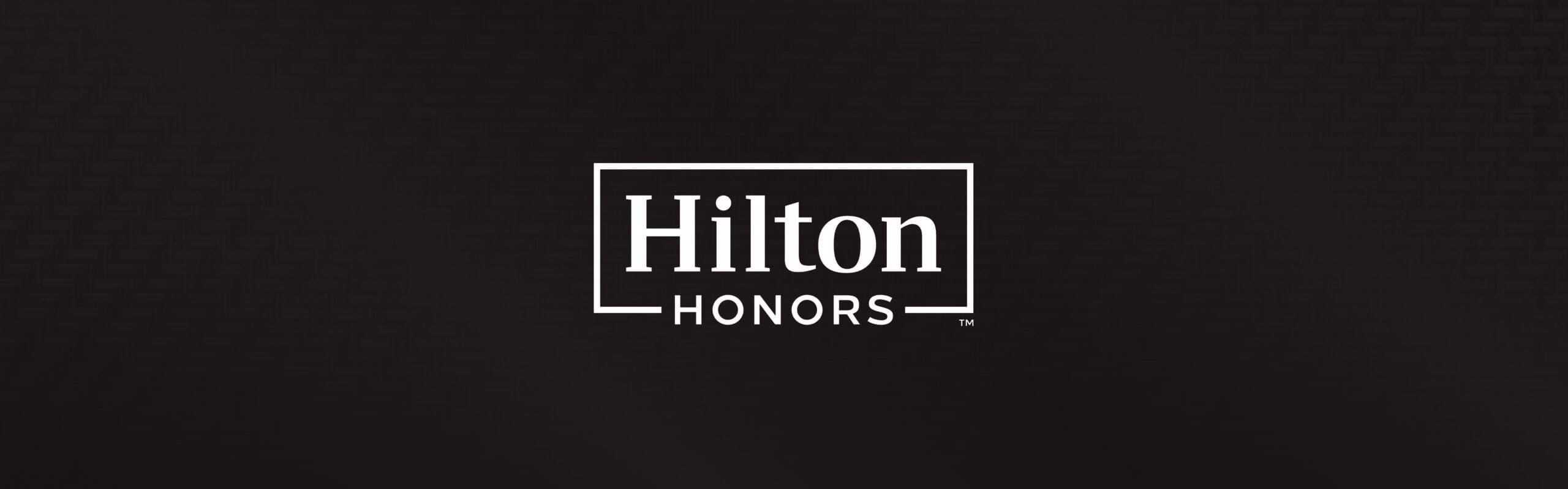 Hilton Honors logo displayed on a dark background.