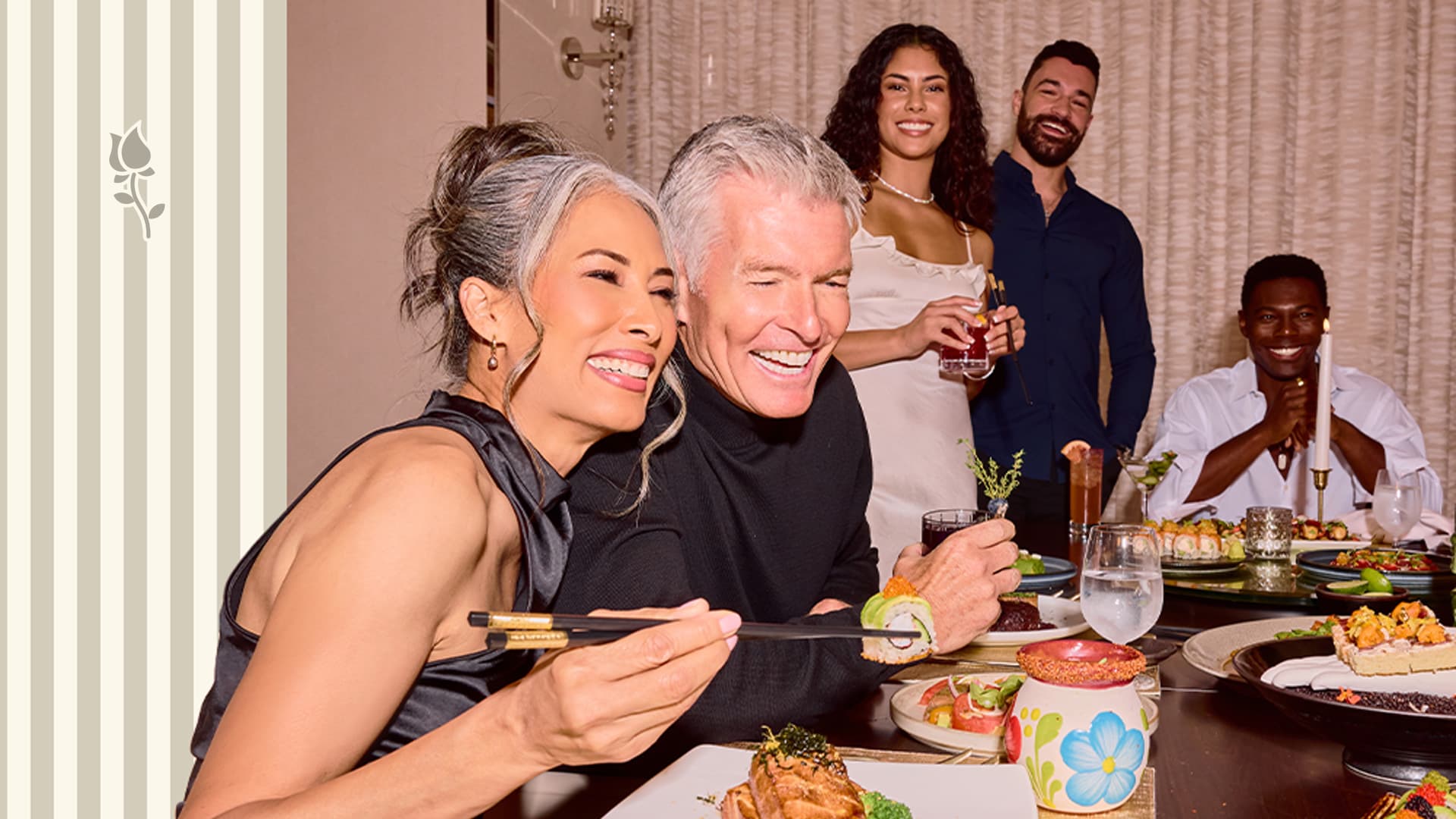 Group of friends enjoying a dinner together, smiling and sharing sushi and drinks at a restaurant table