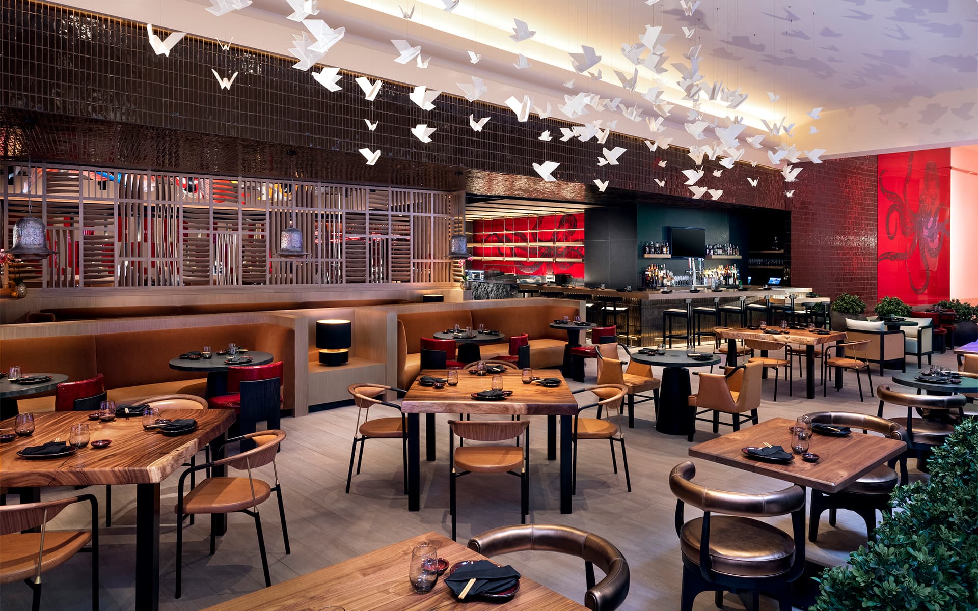Modern Kusa Nori dining room with wood tables, leather seating, suspended origami bird installation, and contemporary Japanese-inspired design.
