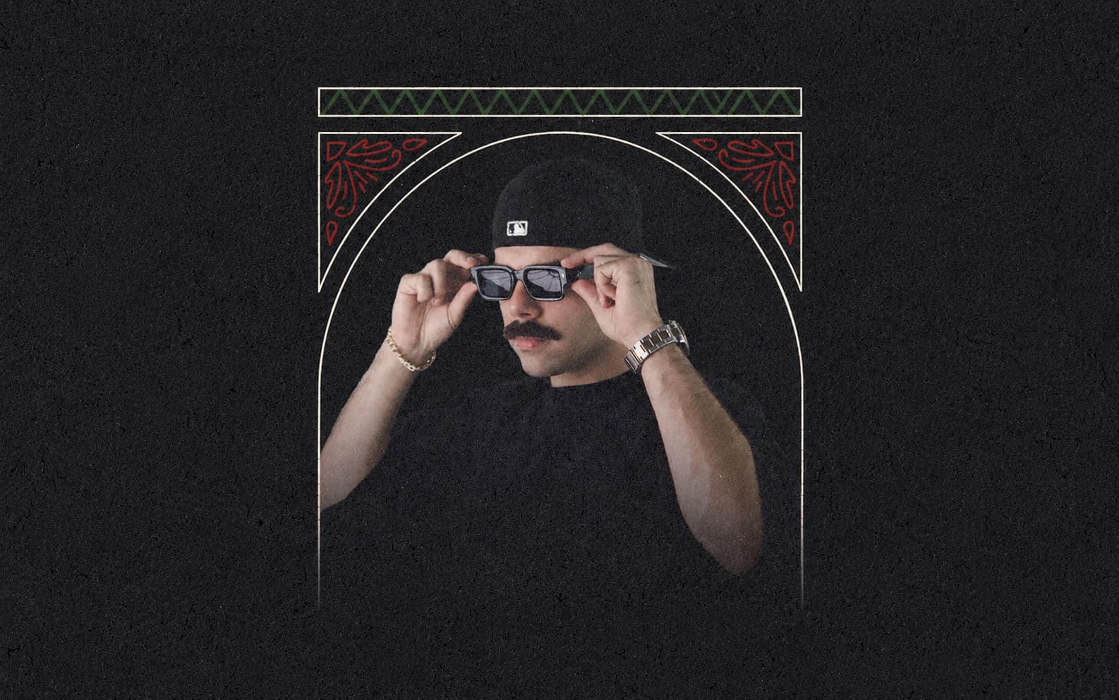 Man wearing a black cap and shirt adjusts his sunglasses against a dark textured background.