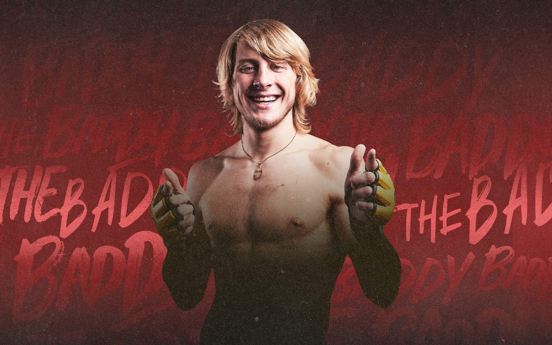 Promotional image of Paddy the Baddy smiling and posing with both thumbs up against a red graphic background.